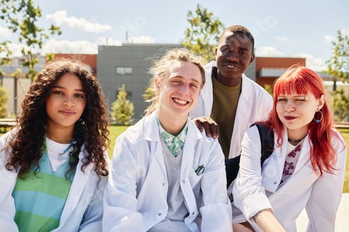 Preview: Portrait of Four Smiling Med Students of Diverse Ethnicity Outdoors on Campus