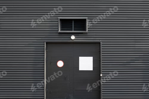 Preview: Grey door in the middle of ribbed metal wall