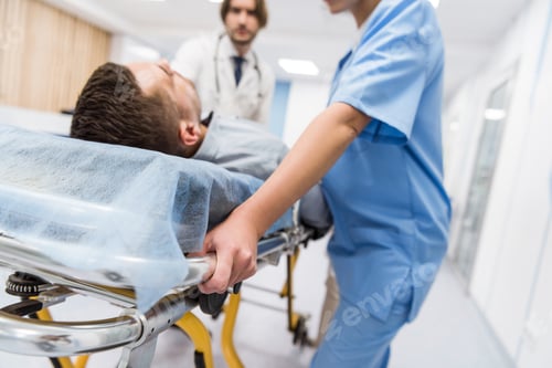 Preview: Cropped view of doctors transportating patient on gurney