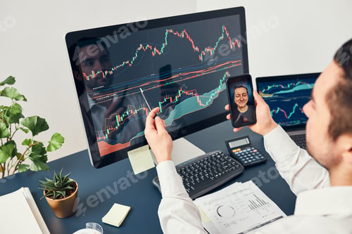 Preview: Businessman trading stocks online. Stock investor discussing numbers at graphs while conversation