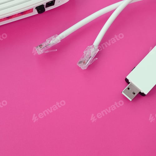 Preview: Internet router, portable USB wi-fi adapter and internet cable plugs lie on a bright pink background