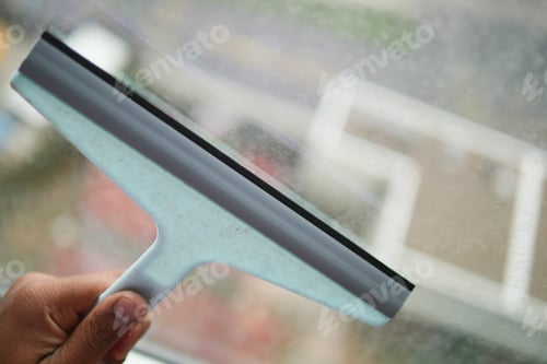 Preview: Cleaning windows with a squeegee.