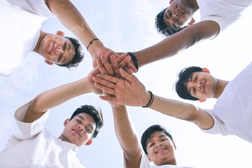 Preview: Group of Happy Diverse Volunteers Joining Stacked Hands Together with Smiles