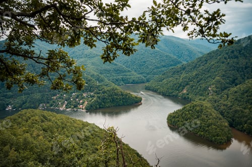 Preview: Beautiful view of a river surrounded by mountains covered with forests