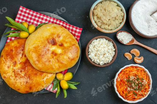 Preview: Close up view of delicous fresh baked pastries kumquats with stem on red stripped towel and salad