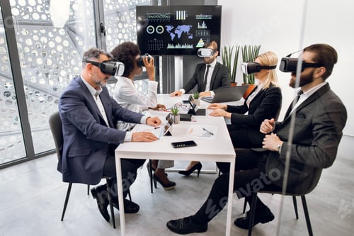 Preview: Multiethnic creative business team using virtual reality headsets at the meeting in modern office