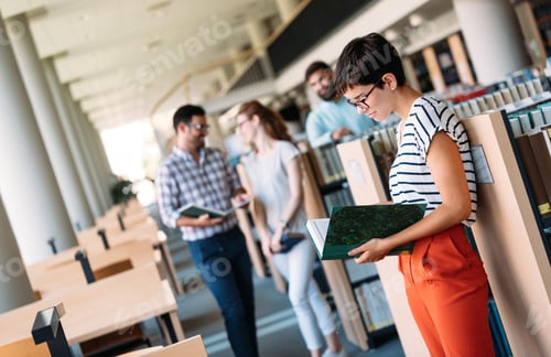 Preview: Young attractive students spending time in library