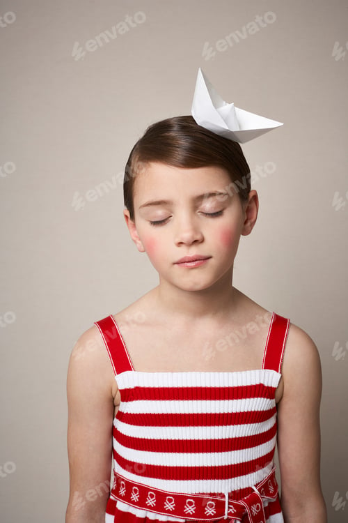 Preview: Portrait of little girl with paper boat on her head