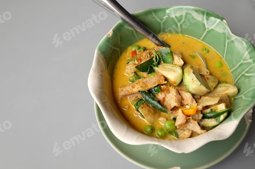 Preview: Thai Green Pork Curry On A Gray Background.