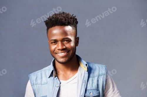 Preview: handsome smiling man standing by gray background