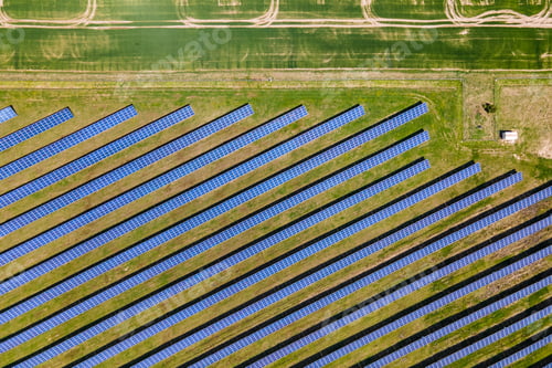 Preview: Aerial view of big sustainable electric power plant with many rows of solar photovoltaic panels