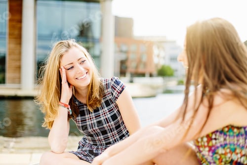 Preview: Friends chatting by canal