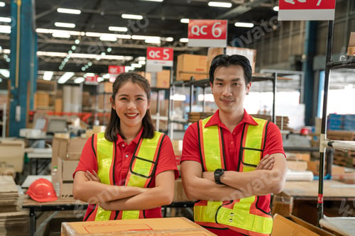 Preview: Portrait of staff worker standing in warehouse looking at camera.