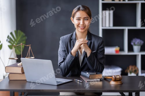 Preview: Attractive lawyer in office Business woman and lawyers discussing contract papers with brass scale o