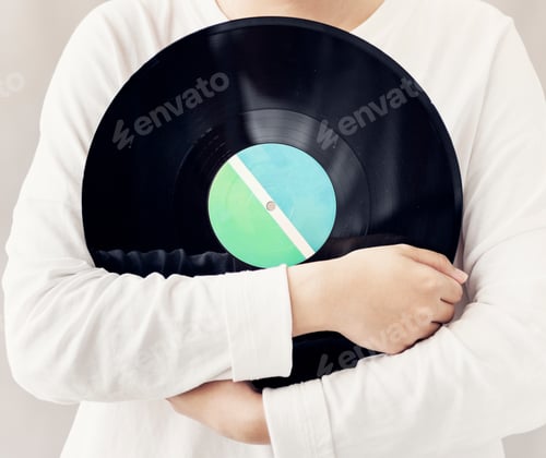 Preview: Closeup of woman holding music vinyl record disc