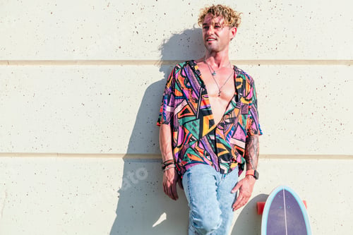 Preview: carefree skater in trendy clothes leaning on wall