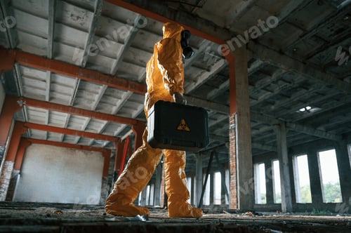 Preview: Man dressed in chemical protection suit in the ruins of the post apocalyptic building