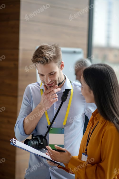 Preview: Two colleagues discussing program details in the office