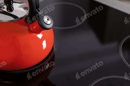 Preview: Modern kettle with whistle on stove, closeup. Space for text