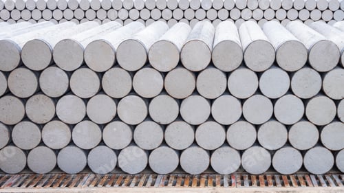 Preview: Pile of many precast micropiles construction material stacked on the floor in industry yard area