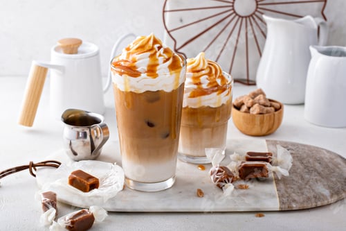 Preview: Iced caramel latte topped with whipped cream and caramel sauce