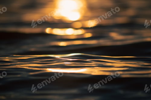 Preview: Close of up a water reflecting Sunset lights