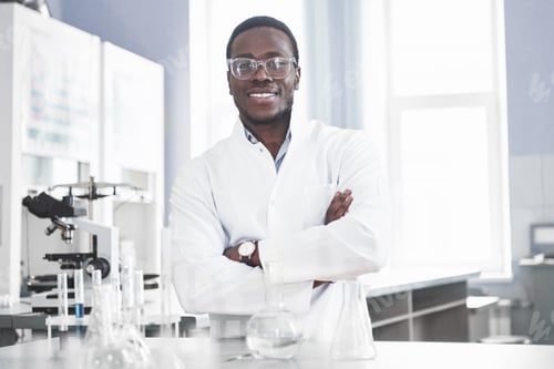 Preview: The scientist works with a microscope in a laboratory conducting experiments and formulas