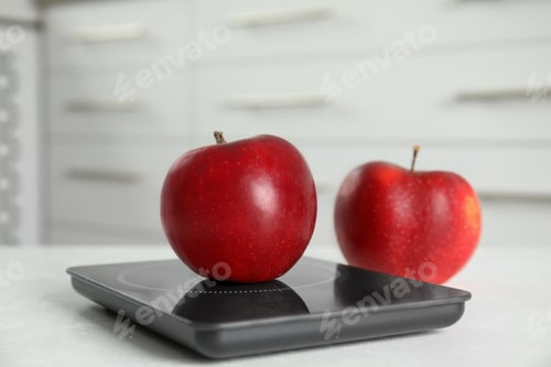 Preview: Red apples and modern digital scale on table