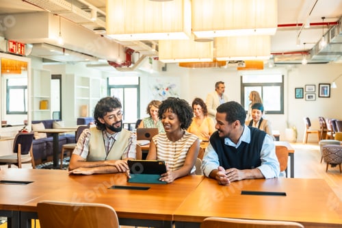 Preview: Diverse colleagues collaborating on tablet in modern coworking office