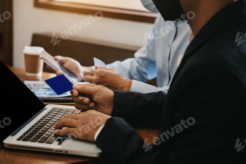 Preview: financial adviser analyzing data with investor at home office.