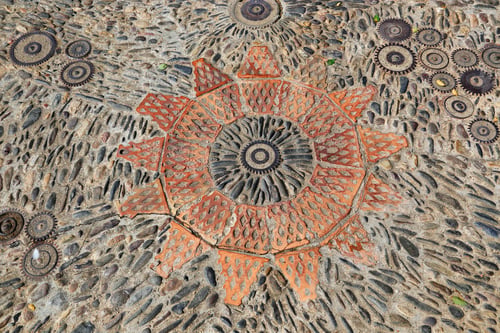 Preview: Patterned floor with pattern from pebbles bricks and gears