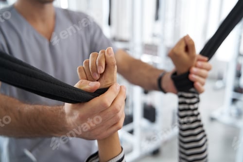 Preview: Woman training in the gym with coach