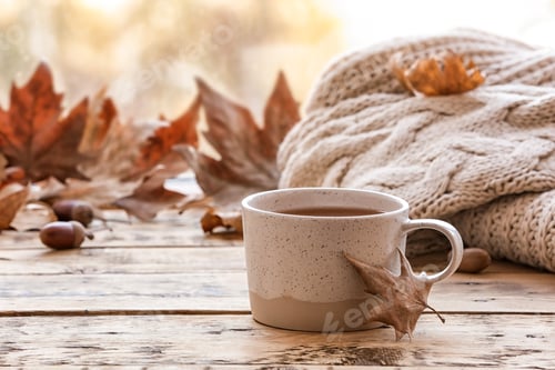 Preview: Composition with cup of hot cozy drink and autumn leaves on windowsill. Space for text