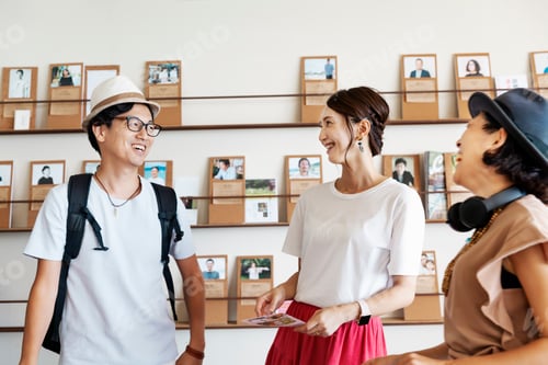 Preview: Group of young Japanese professionals talking to each other in a co-working space.