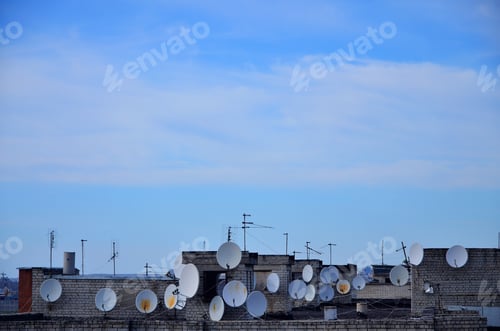 Preview: A lot of satellite and cable television antennas are located on the rooftop of a multi-storey
