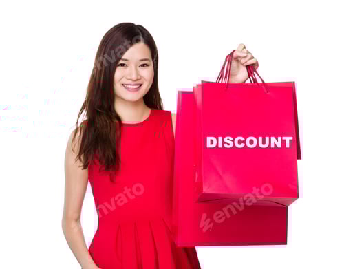 Preview: Woman hold with paper bag and showing a word discount