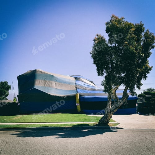 Preview: termite extermination fumigation ten over a house on a clear day
