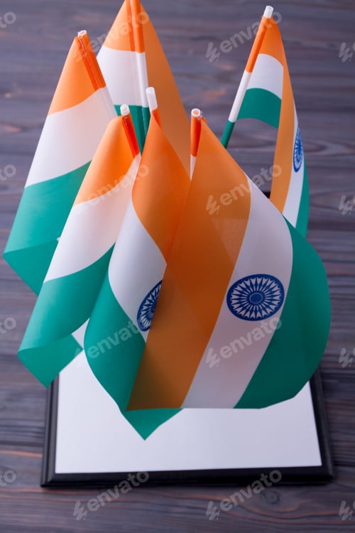 Preview: Vertical shot collection of indian flags on grey wood background.
