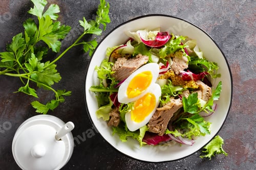 Preview: Diet food tuna salad with boiled egg, canned fish, onion and green lettuce top view