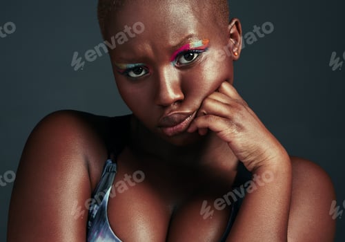 Preview: Cropped shot of a beautiful woman wearing colorful eyeshadow while posing against a grey background