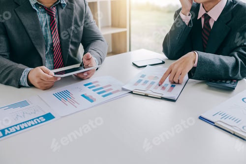 Preview: Business Professionals Discussing Data Analysis at a Table