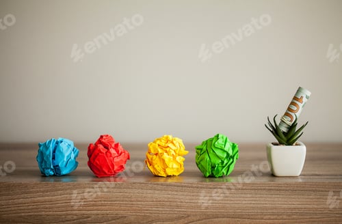 Preview: Great idea concept. Crumpled colorful paper on wooden table. Copy space