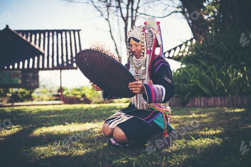 Preview: Akha in the north of Thailand enjoying coffee from shell by bamboo basket with traditional cloth.