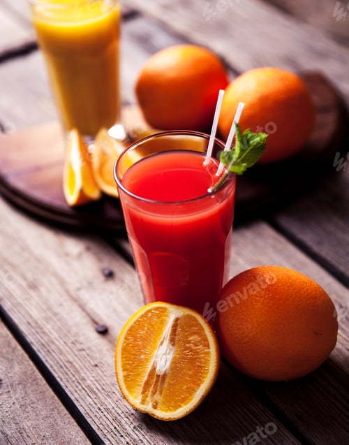 Preview: Orange juice in glass with mint, fresh fruits on wooden background a