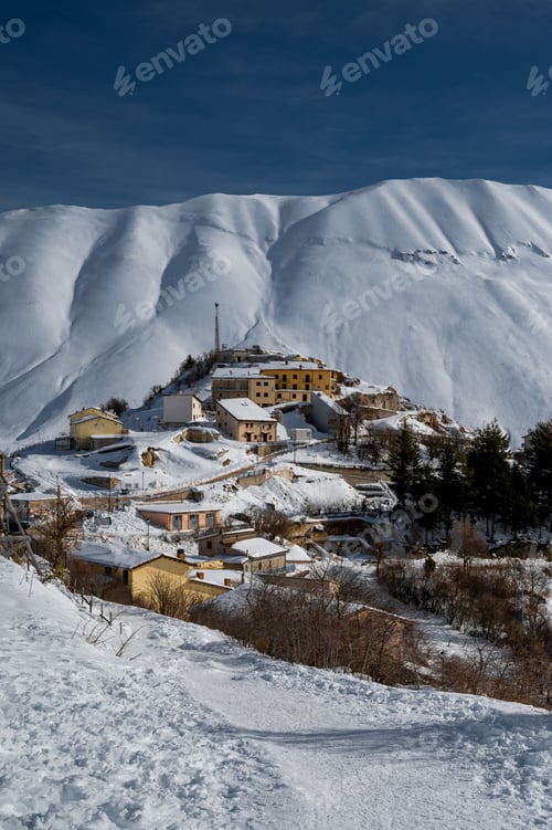 Preview: Landscape of sow covered peaks of majestic mountains in Castelluccio di Norcia in wintertime