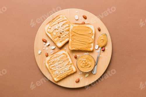 Preview: Peanut butter sandwiches or toasts on light table background.Breakfast. Vegetarian food