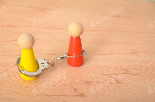 Preview: The handcuffs connecting the two figures suggesting a sense of restriction or obligation.