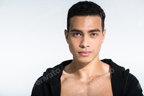 Preview: handsome mixed race man in black sports jacket looking at camera on white