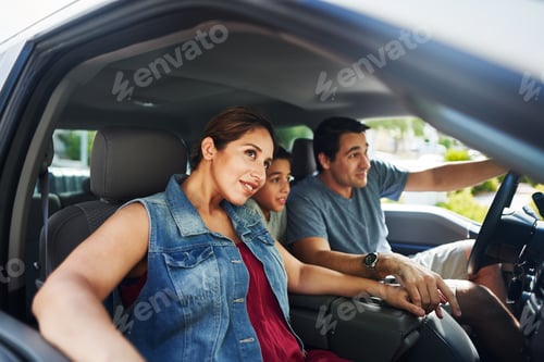 Preview: hispanic family with mother, father and son sitting in truck looking outside
