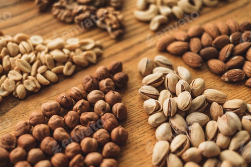 Preview: Different types of nuts, nut mix of almonds, hazelnuts, cashews, peanuts on a wooden board. Close up